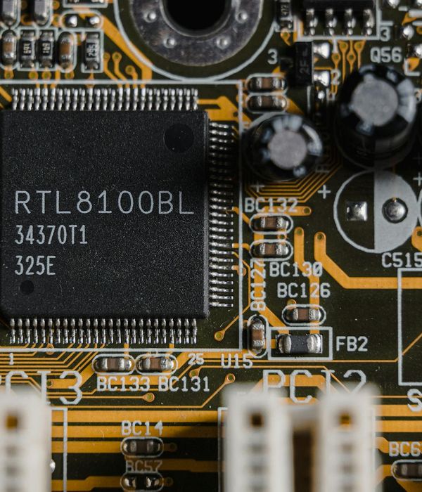 Professional laptop motherboard diagnostic and repair process on specialized workstation