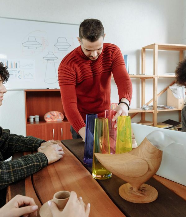 Professional team of technicians standing together in modern workshop environment