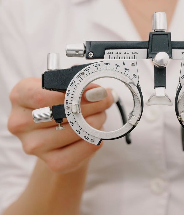 Woman specialist working attentively with precision instruments and diagnostic equipment